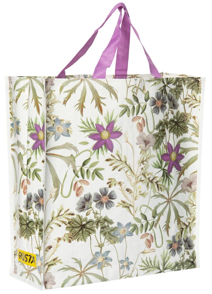 Stor shoppingkasse med blommigt mönster och lila handtag.