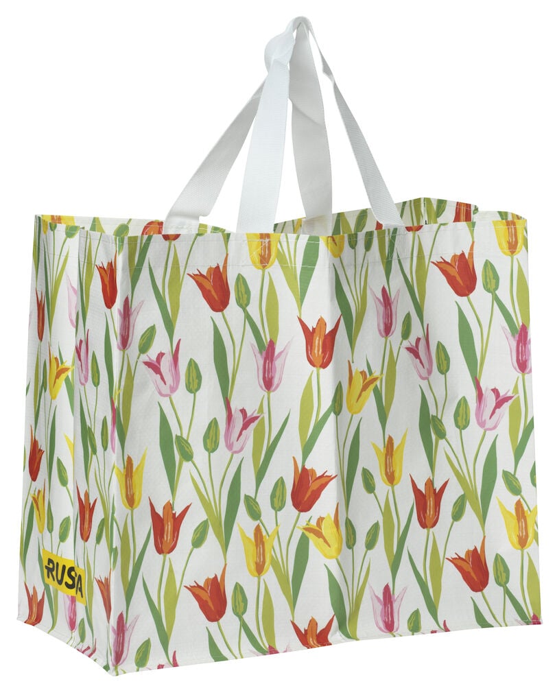 Ostoskassi Medium Kevät valkoisella, punaisella, keltaisella ja pinkillä tulppaanikuviolla ja valkoisilla kahvoilla.