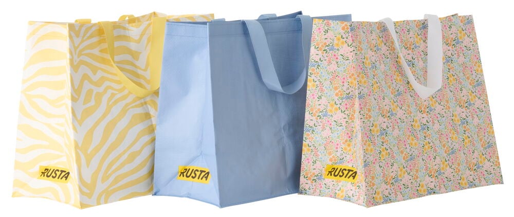 Ostoskassi Medium Kevät, vaaleanpunainen kukkakuvioinen kassi valkoisilla kahvoilla, näytetään sinisen ja keltaisen seeprakuvioisen kassin kanssa.