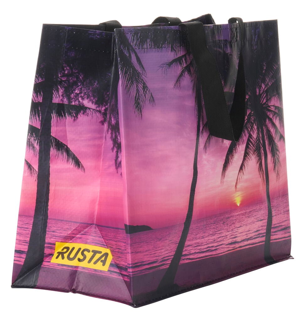 Ostoskassi Medium Kesä, jossa pinkki-violetti auringonlaskupainatus, mustat palmupuut ja mustat kahvat.