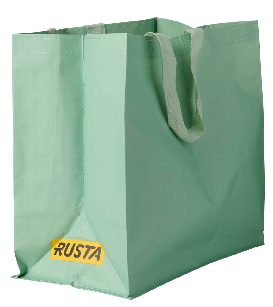 Eine hellgrüne Einkaufstasche Medium Sommer mit zwei Griffen und einem gelben Rusta-Logo vorne, aufrecht stehend.