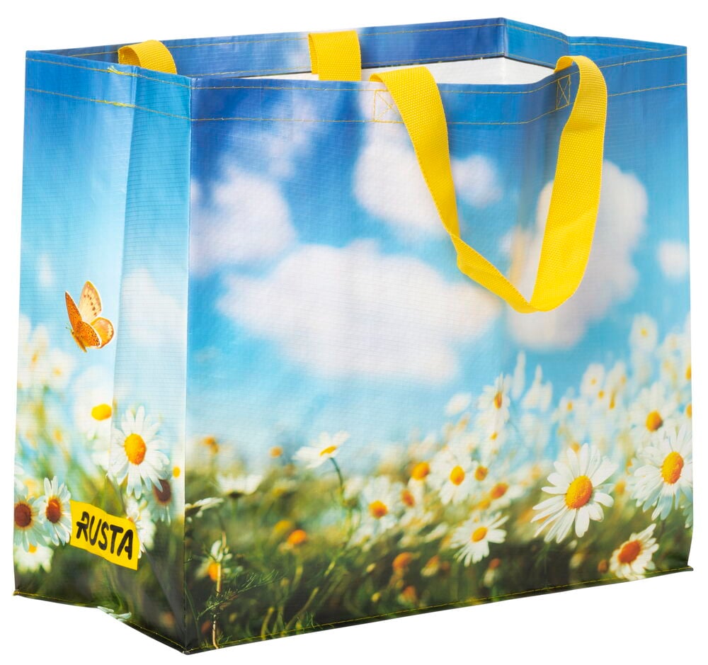 Einkaufstasche mit sommerlichem Blumenmuster und gelben Griffen.