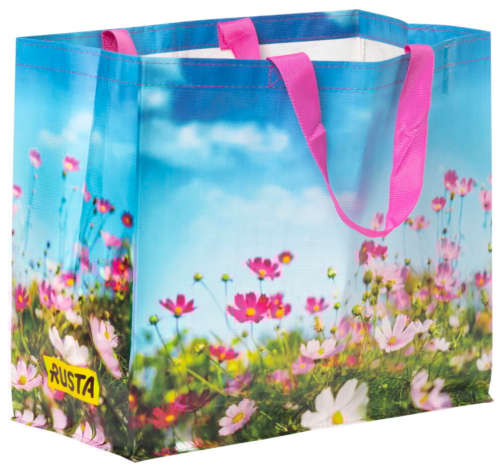 Einkaufstasche mit Sommerblumen und rosa Griffen.