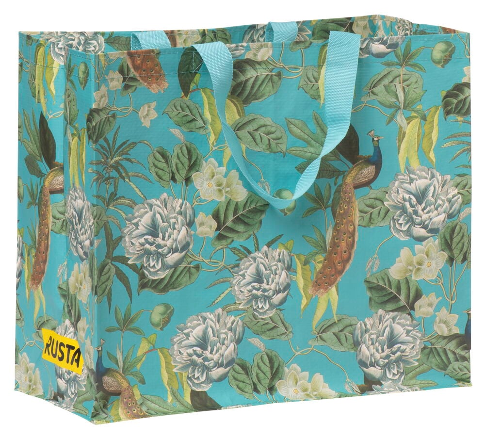 Shoppingkasse med färgglatt blommönster och textilhandtag.