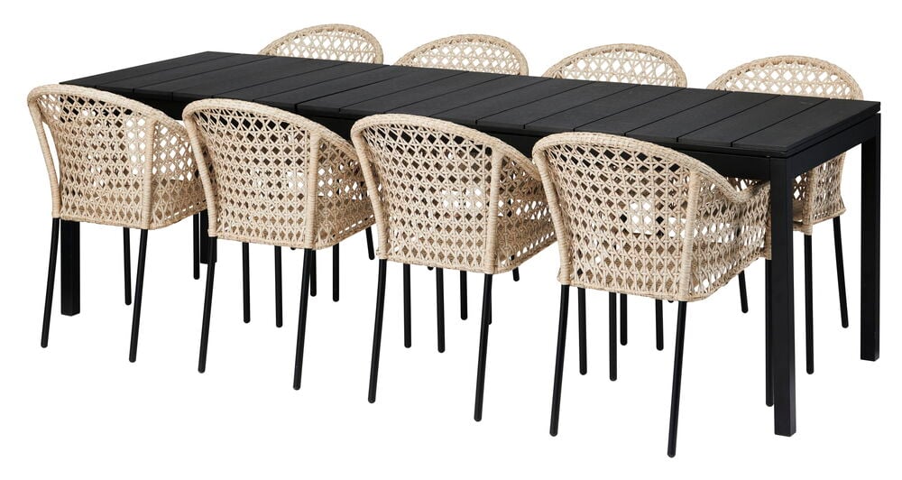 Musta jatkettava pöytä kahdeksalla luonnonvärisellä tuolilla.