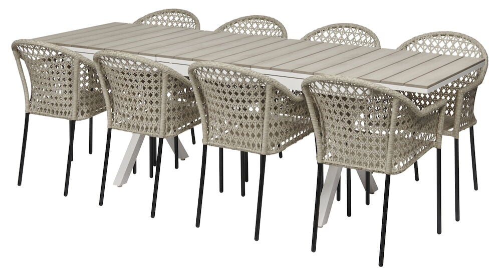 Valkoinen jatkettava pöytä, kahdeksan rottinkituolia.