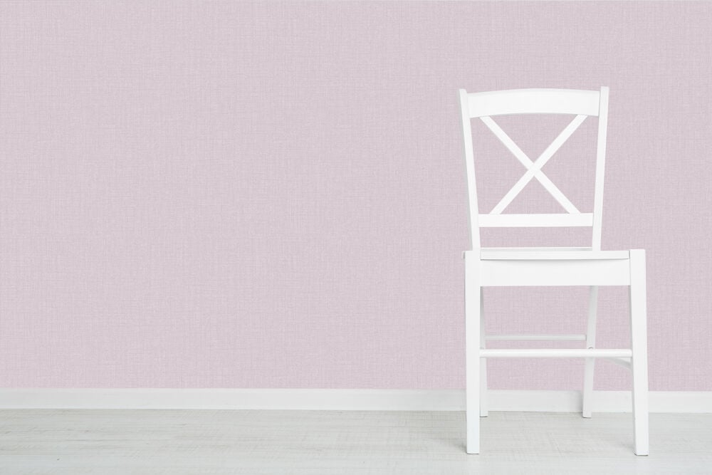 Vit stol framför lila strukturtapet och ljust golv.