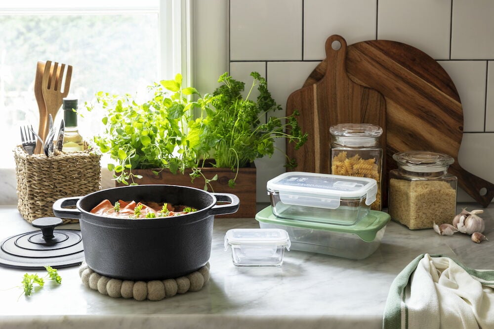 Svart gryta på beige ull grytunderlägg i kök.