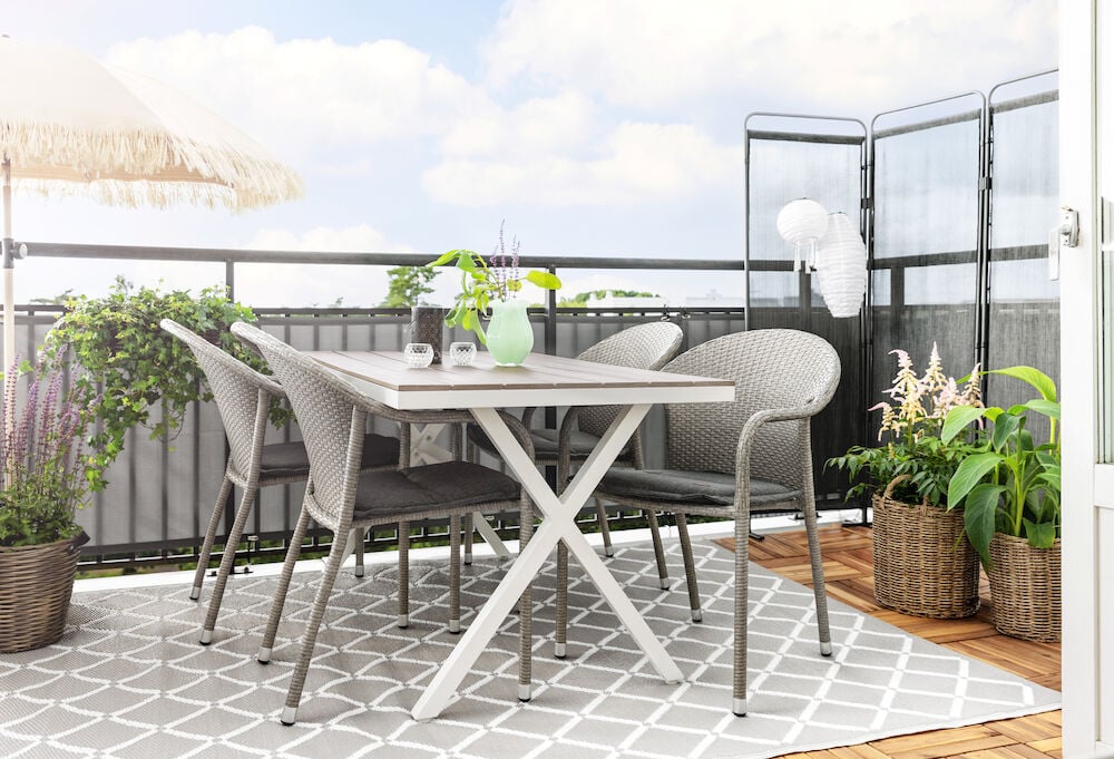 Suorakulmainen valkoinen pöytä, sopii ulkokäyttöön.