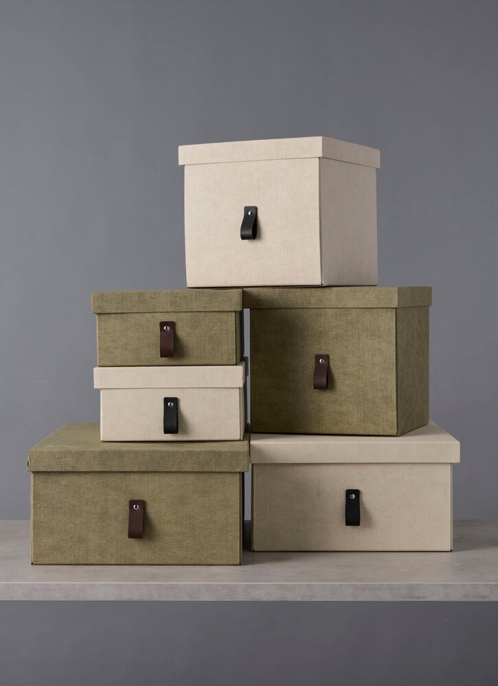 Viisi pinottavaa säilytyslaatikkoa beigessä ja vihreässä värissä.