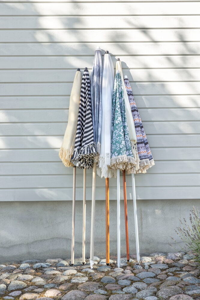 Valkoinen varjo hapsuilla nojautuneena seinää vasten.