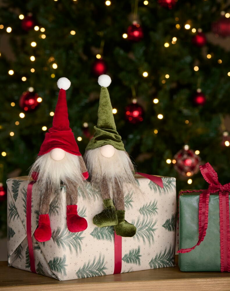 Zwei Weihnachtswichtel Albert 21 cm Wichtel, einer rot, einer grün, sitzen auf weißen und grünen Geschenkkartons.