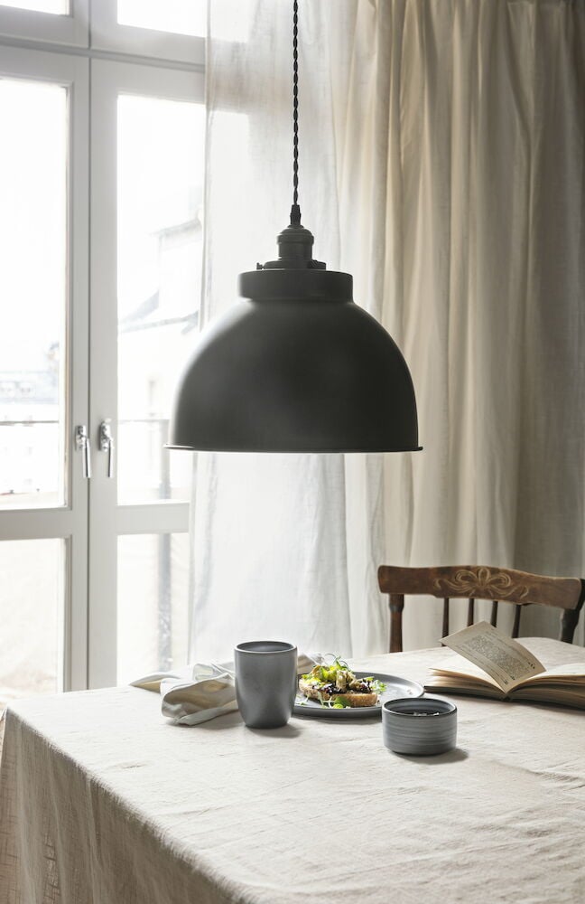 Beige puuvillaliina hapsuilla pöydällä.