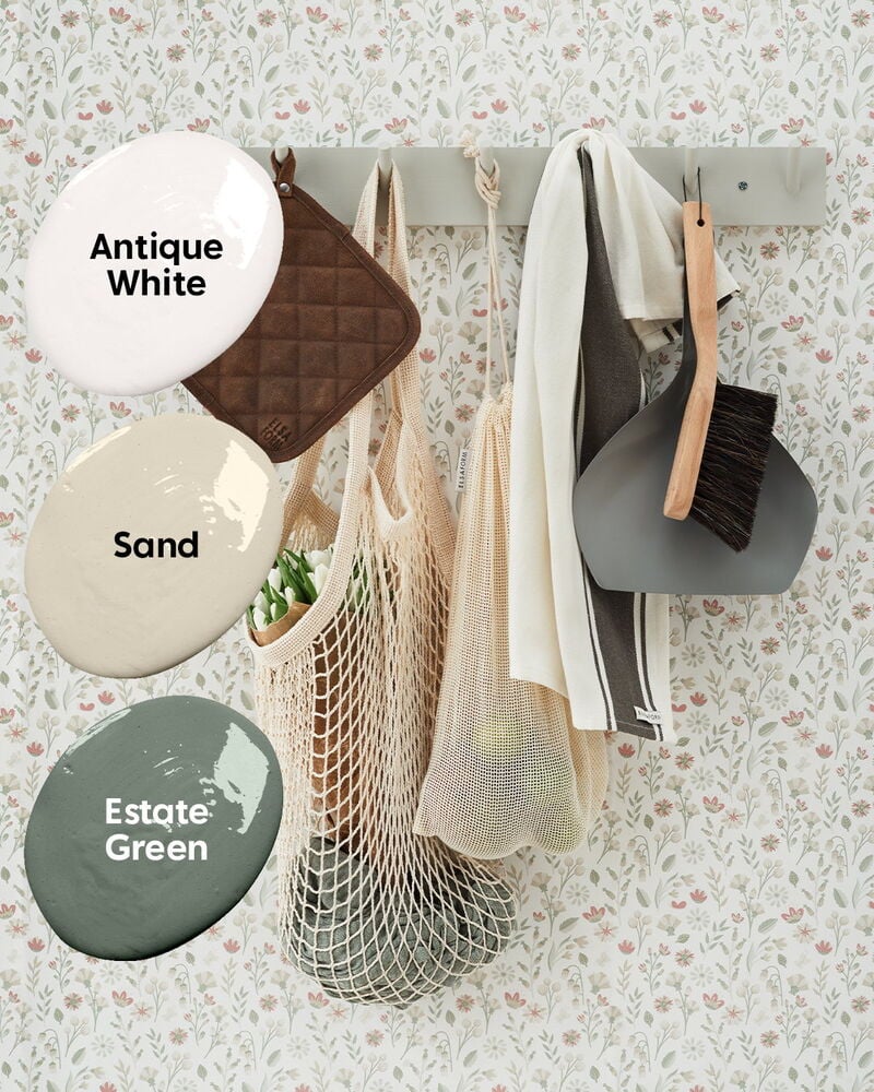 Blommig ljus tapet med krokar och hushållsartiklar.