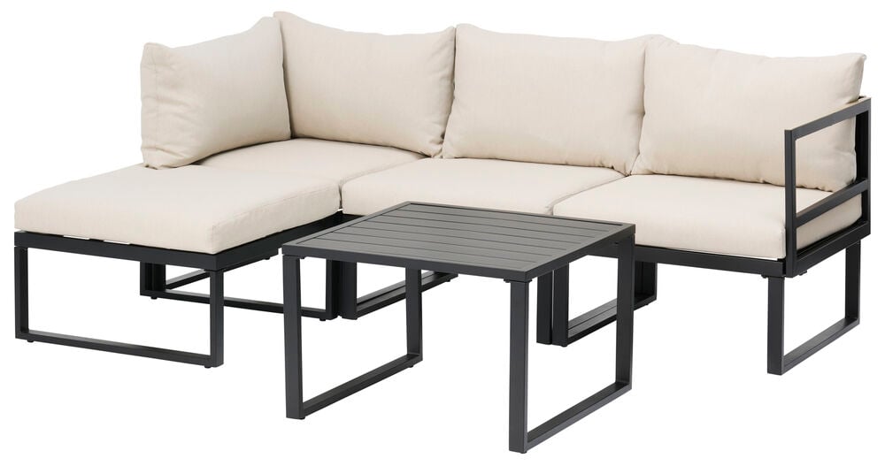 Musta loungemoduuli, jossa beige vettähylkivät tyynyt.