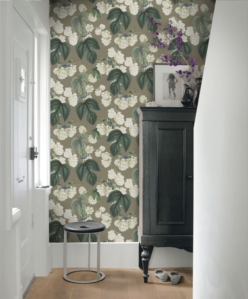 Mörk beige tapet med små fåglar och blommor.